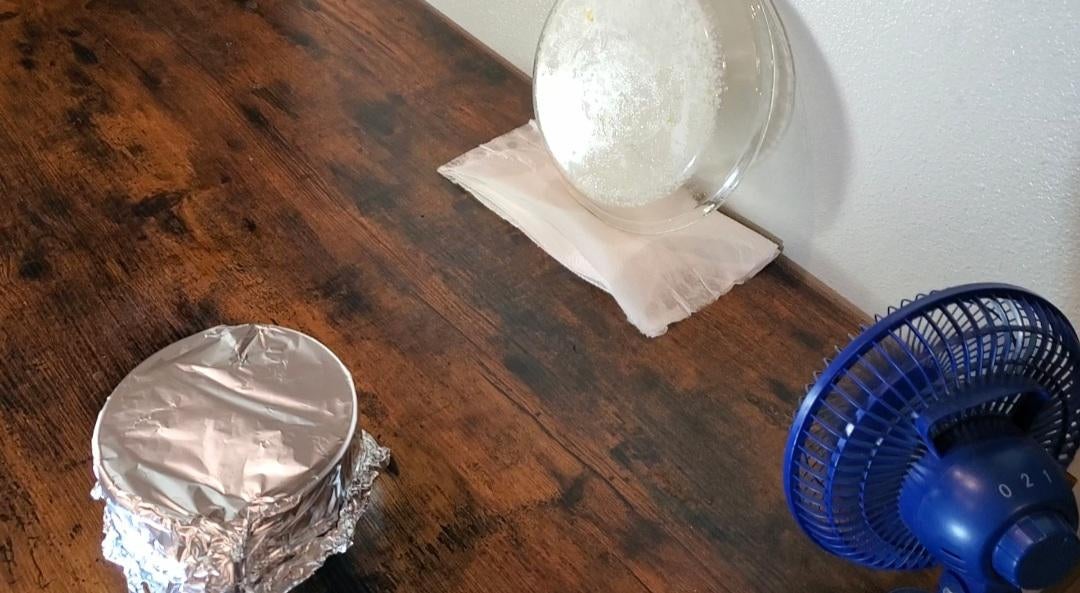 Crystal dish propped against the wall with a fan blowing indirectly to help speed up the drying process
